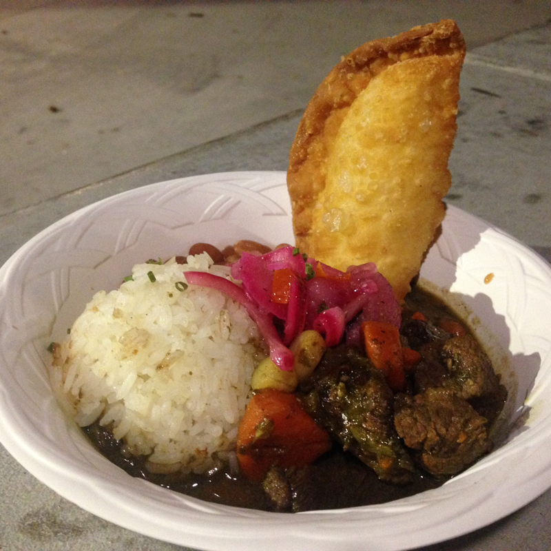Beef stew, with rice, pickled stuff, and a cheese empanada.